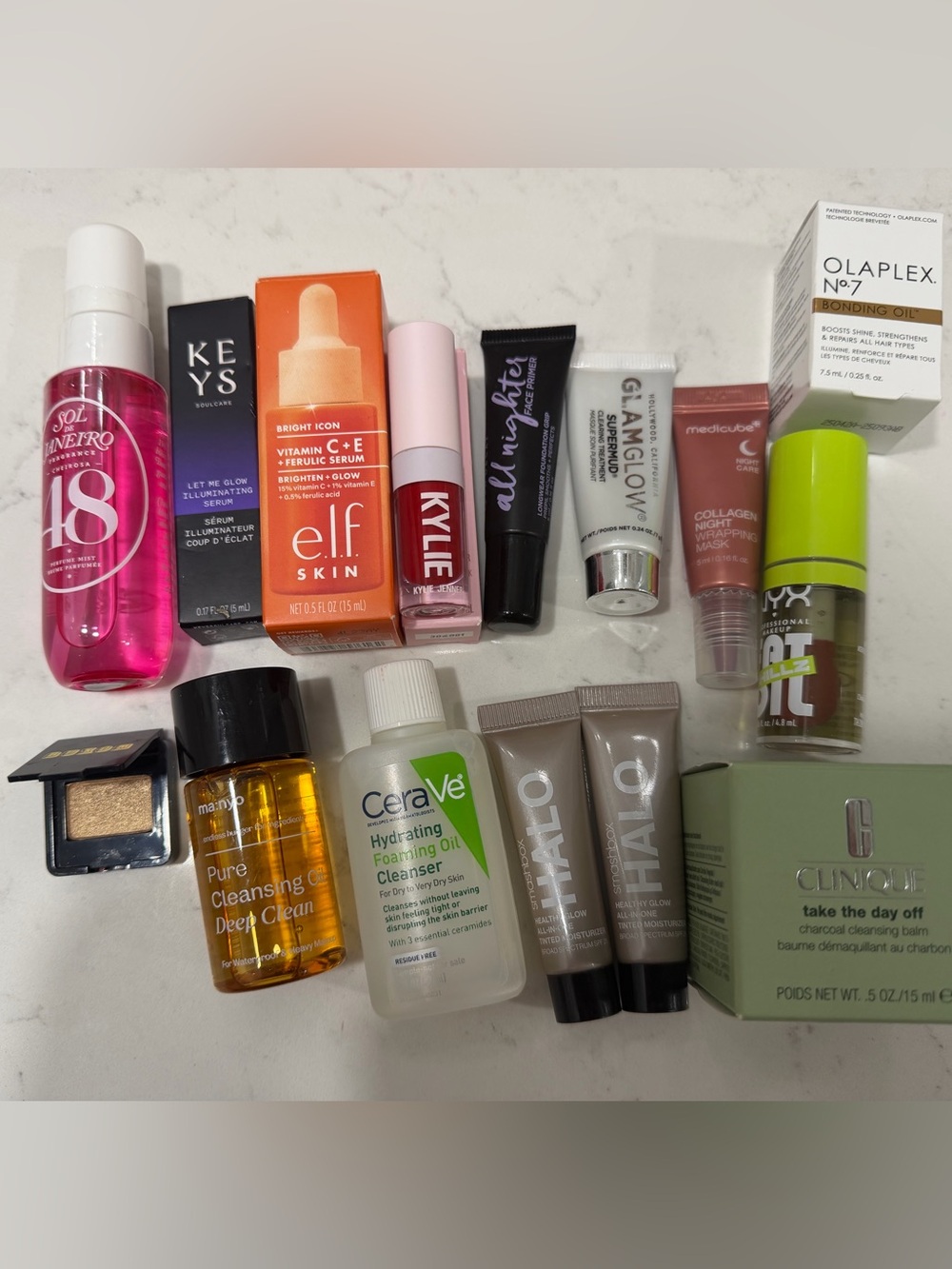 15 different mini sized skincare and makeup products + pink makeup bag